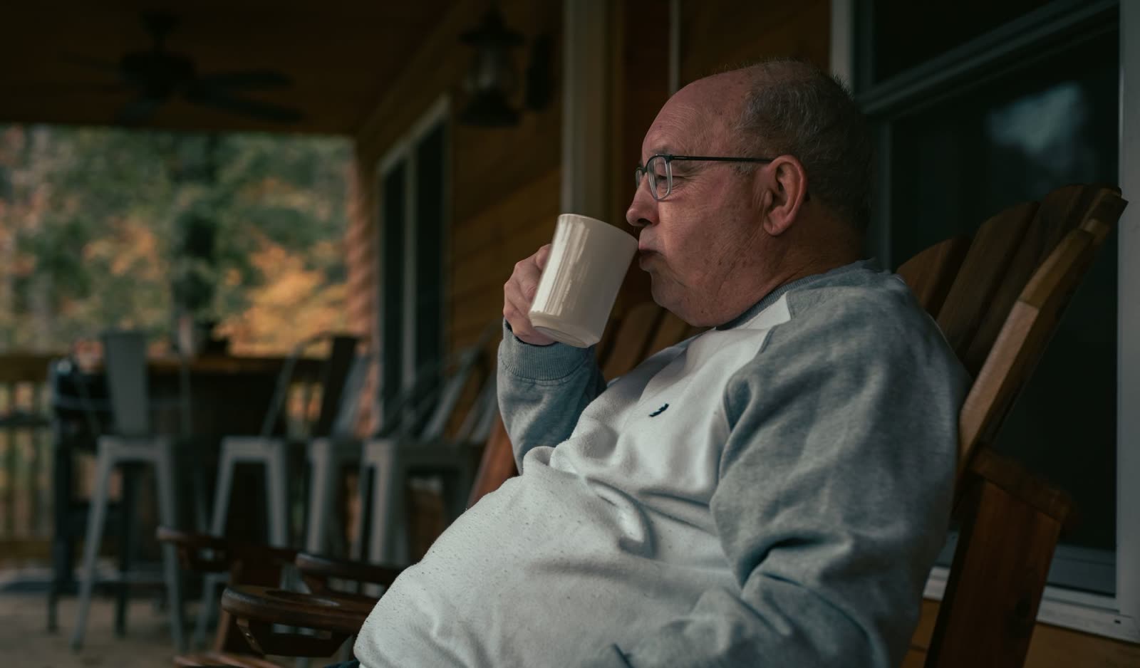 people in light jackets walking on a crisp early fall morning / family drinking coffee on a porch on a cool autumn morning / golden sunrise over a small southern town in early fall