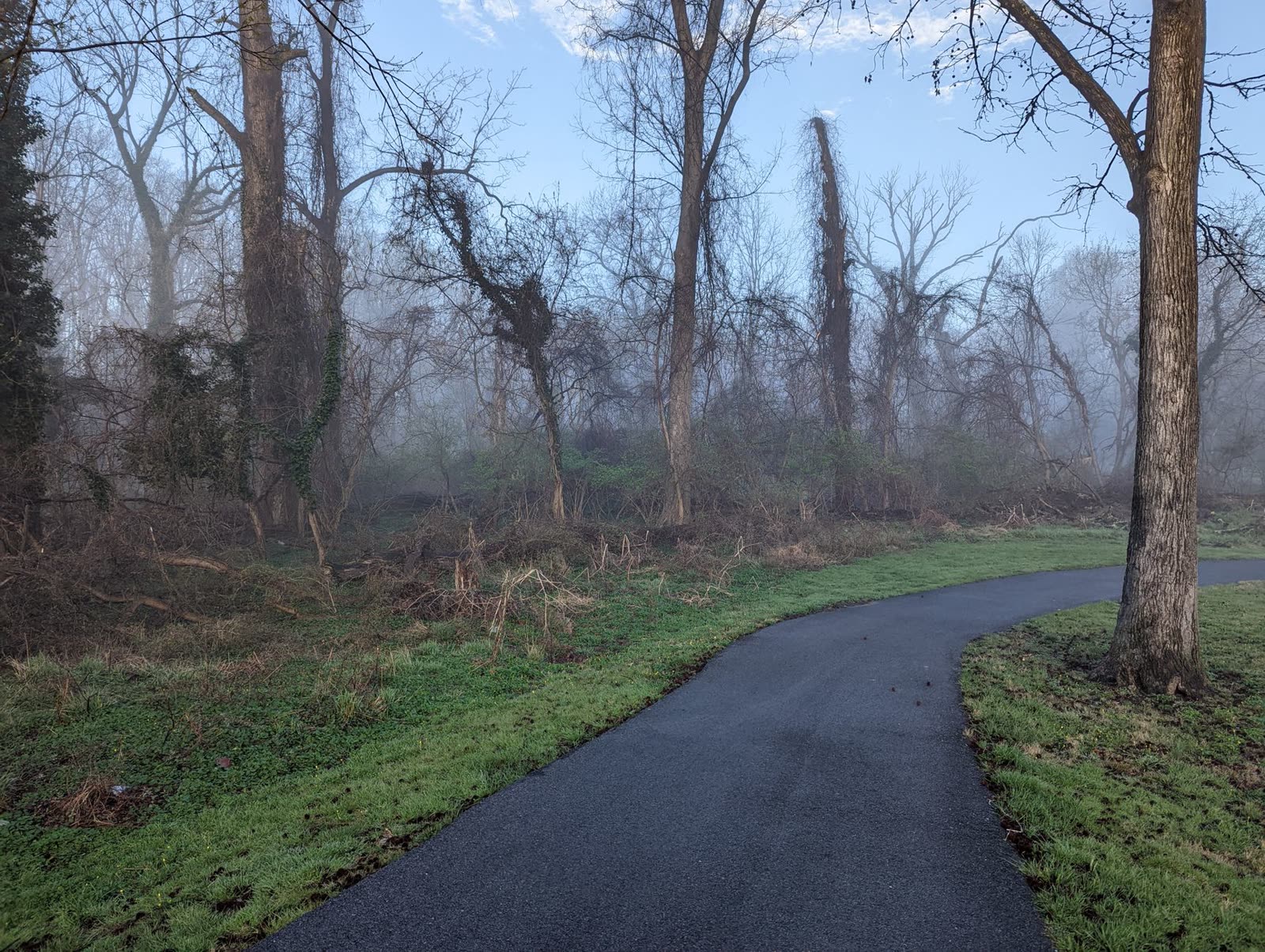 paved riverside trail at sunrise