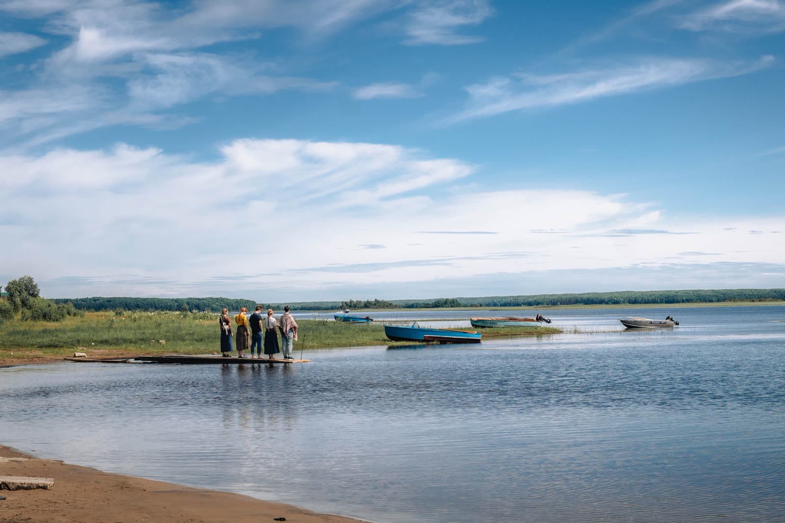 people standing on a lakeside dock under a clear evening sky / satellite view of the atlantic ocean during hurricane season / rain clouds building over a southern lake in autumn
