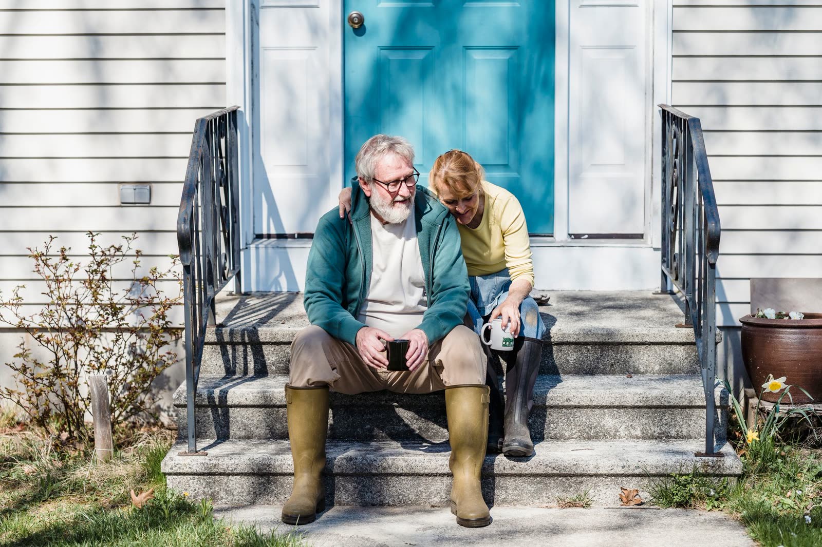 people in short sleeves walking a riverside trail on a warm sunny afternoon / family on a porch with coffee on a cool sunny morning / clear blue sky over pine trees in early autumn